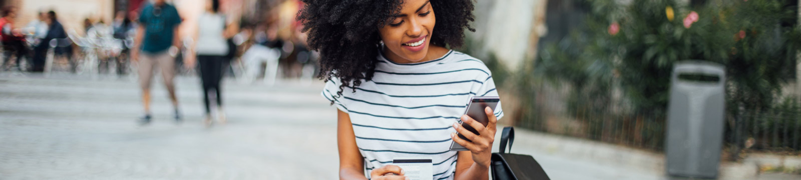 Woman holding phone outdoors