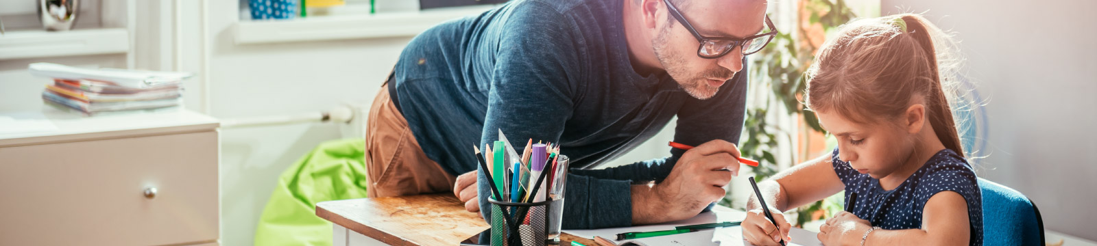 Father helping daughter with school work